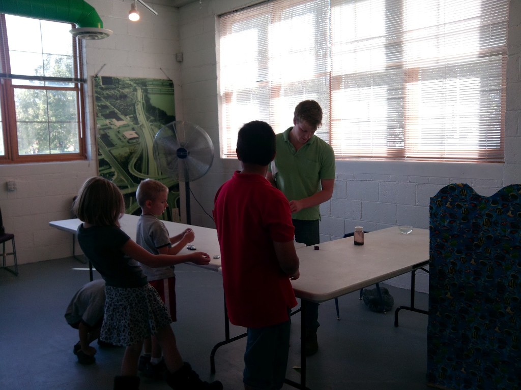 A volunteer stays after to answer questions about earth sciences.